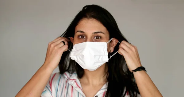 Casual Young Woman Removing Surgical Mask — стоковое фото