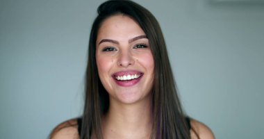 Beautiful young woman bursting laughing out loud. Pretty girl real life spontaneous smile and laugh