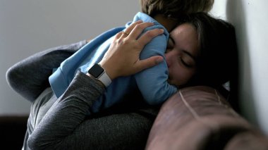 Mother and child authentic love and affection moment, son embracing mom