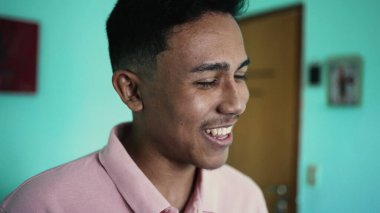 One happy hispanic man laughing and smiling at camera
