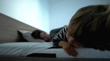 Mother and child son in morning bed love care and affection 