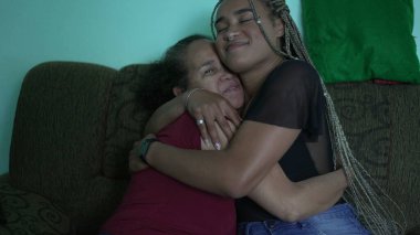 A latina black daughter embracing older mother. Family love and embrace
