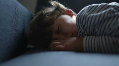 Little boy resting sleeping on sofa. child asleep