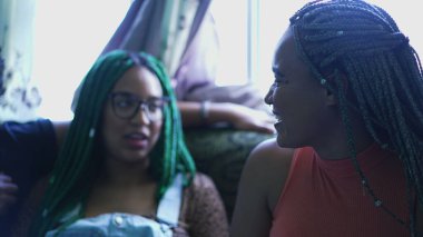 Fun friends talking together sharing gossip. Three hispanic women