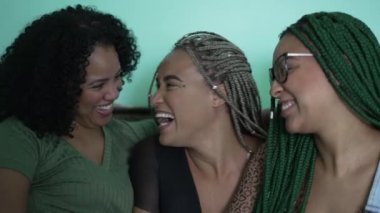 Three happy black African American women laughing and laughing. Authentic real life laugh and smile