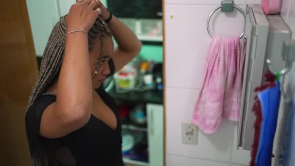 African Woman Adjusting Box Braids Hairstyle Front Bathroom Mirror — Vídeo de stock
