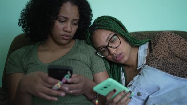 Bored Two Female Friends Looking Cellphone Screens — Video Stock