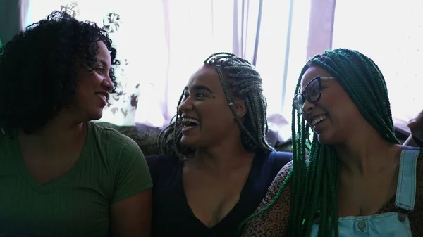 Girlfriends laughing together. Three black women smiling. Real life happiness emotion