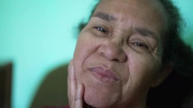 One senior hispanic woman looking at camera smiling. Portrait of a South American older lady closeup face