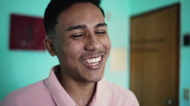 One happy hispanic man laughing and smiling at camera