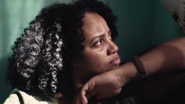 One depressed black woman at home. A concerned African girl sad expression