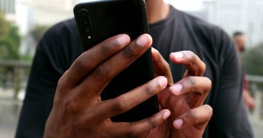 African black man using cellphone in street