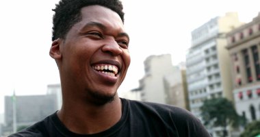 African black man smiling and laughing outside, real authentic people smile and laugh