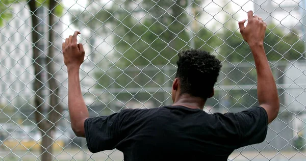 African Black Man Leaning Metal Fence Watching Game — ストック写真