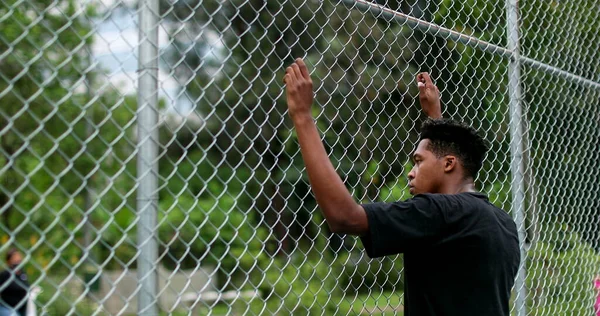 African Black Man Leaning Metal Fence Watching Game — Foto de Stock