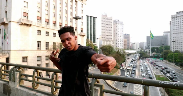 African artist performing urban dance in downtown city