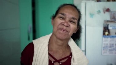A senior hispanic woman portrait face looking at camera with serious expression