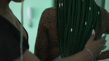 Two black female friends with box braids hairstyle. Young latina women with braided hair