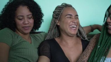 Happy female friends embrace. Three happy black African women laughing and smiling