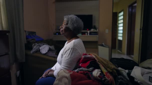 Μια Στοχαστική Ηλικιωμένη Μαύρη Γυναίκα Που Κάθεται Δίπλα Στην Κρεβατοκάμαρα — Αρχείο Βίντεο