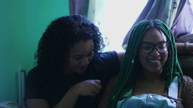 Fun friends talking together sharing gossip. Three hispanic women