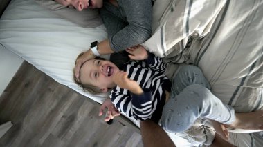 Mother and child son in morning bed love care and affection 