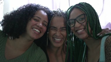 Portrait of three happy black latina women looking at camera smiling