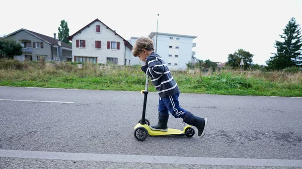 Child Rides Toy Scooter — Zdjęcie stockowe