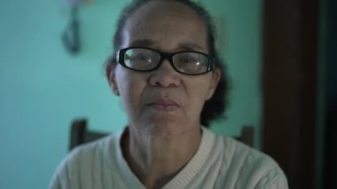 A black Latin woman portrait looking at camera with serious expression