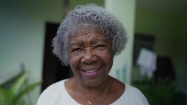A Brazilian senior lady portrait standing outside smiling at camera