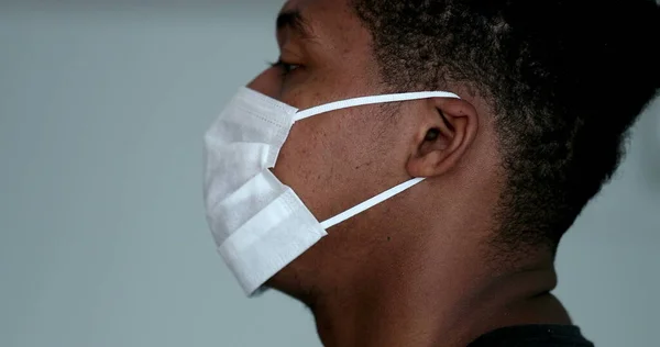 Profile African Man Putting Surgical Face Mask — 图库照片