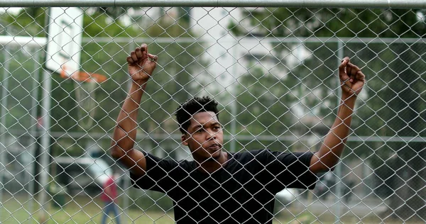 Pensive Young Black Man Leaning Metal Fence Contemplative Mixed Race — Stockfoto