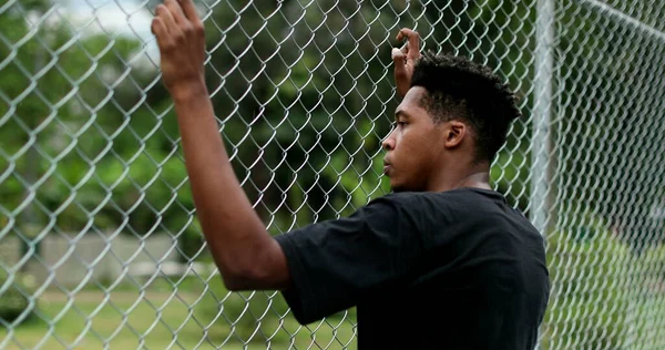 Contemplative Young Black Man Leaning Metal Fence — Foto Stock