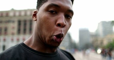 Black man holding smartphone device reacting to bad news