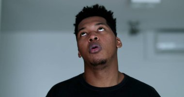 Annoyed bored black man rolling eyes