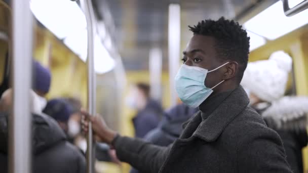 Black Man Holding Bar Subway Metro Wearing Covid Surgical Face — ストック動画
