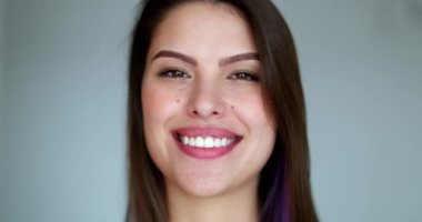 Orta parmak gösteren genç bir kadın, tavırları olan güzel bir kız gülümserken saldırgan bir hareket gösteriyor.