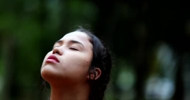 Contemplative young woman closing eyes in meditation. Close-up girl face eye closed