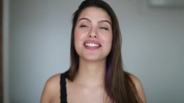 Beautiful young woman giving testimony. Pretty girl face talking to camera feeling happy