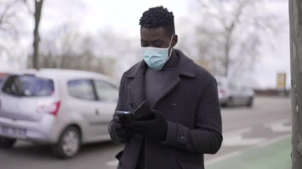 Black Man Wearing Covid Face Mask While Walking Looking Cellphone — Stok video