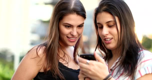 Candid Young Women Looking Smartphone Screen Girlfriends Checking Cellphone Frowning — Vídeo de stock
