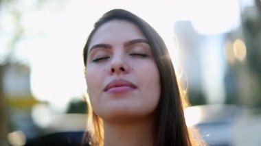 Young woman in contemplation and meditation outside. Girl face taking a deep breath