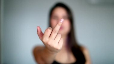 Orta parmağı kameraya gösteren kişi. Genç kadın hareketleri.