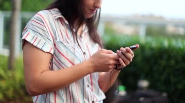 Teen young woman using smartphone outside