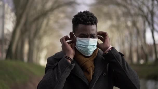 African Man Putting Covid Face Mask While Walking Pandemic Prevention — Video Stock