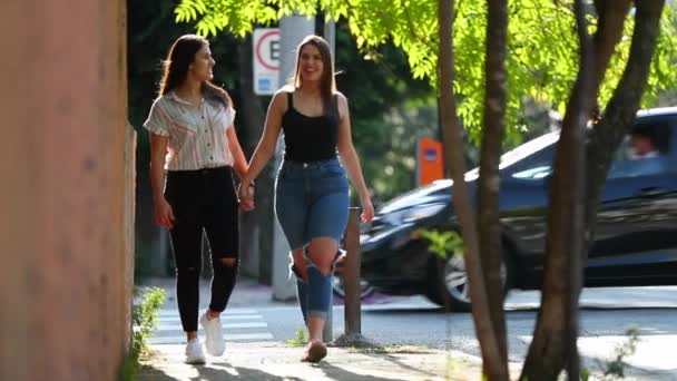 Two Lesbian Girlfriends Walking City Sidewalk Holding Hands — Video