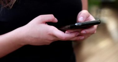 Young millennial woman using smartphone