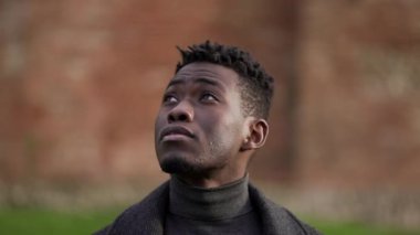 Thoughtful black African man portrait face close-up, tracking shot