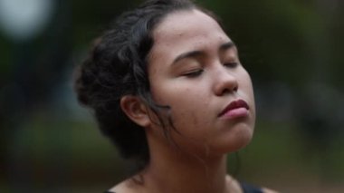 Pensive hispanic girl standing outside. Thoughtful casual latina young woman thinking in contemplation outdoors