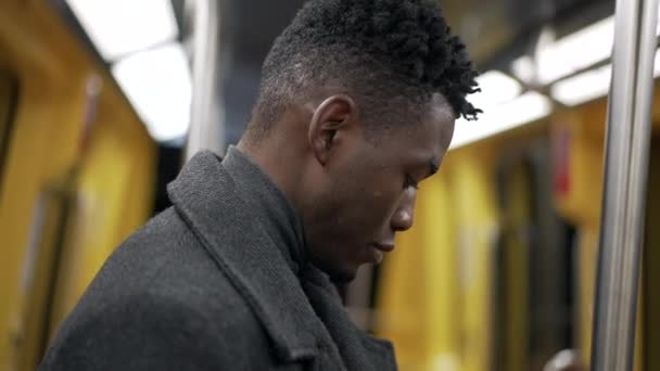 Young Black Man Riding Sunbway Metro Underground Commuting — Stockvideo